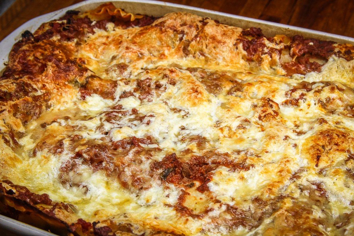 Top with a layer of sauce and plenty of cheese, then bake to a golden brown. 