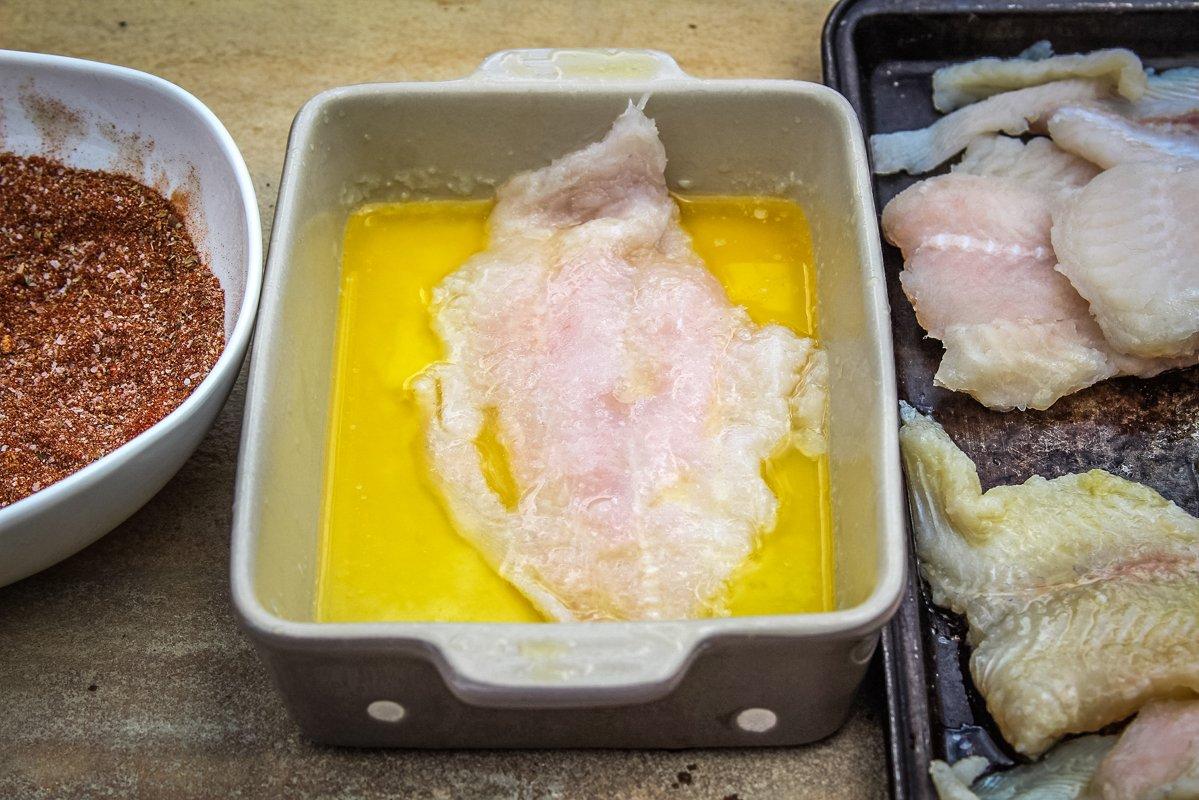 Dip each fillet in melted butter before seasoning.