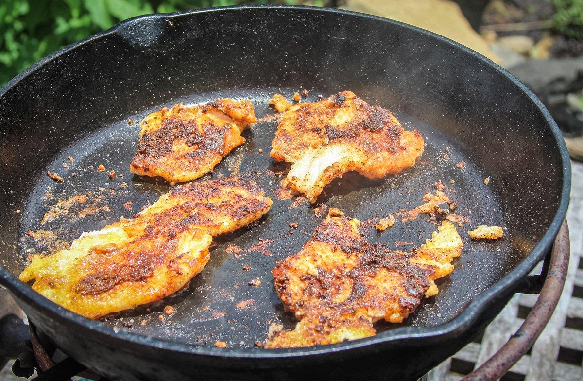 Drop the fillets directly onto a very hot, dry iron skillet.