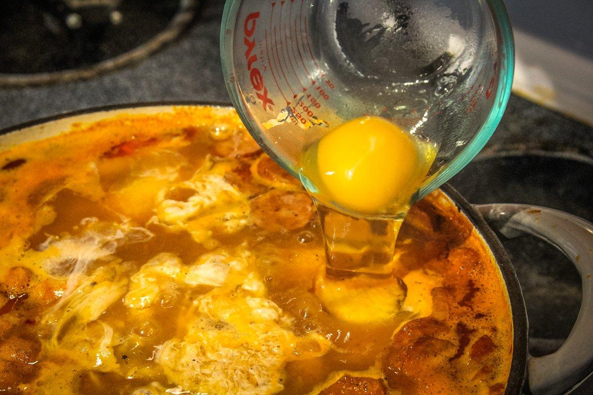 When the stew is almost finished, gently drop the eggs, one at a time, into the broth to poach.