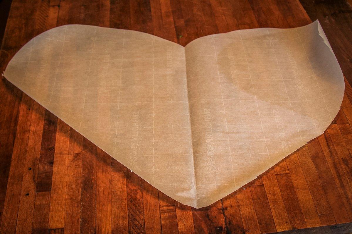 Channel your inner pre-schooler to cut the parchment paper into giant hearts to make folding easy.