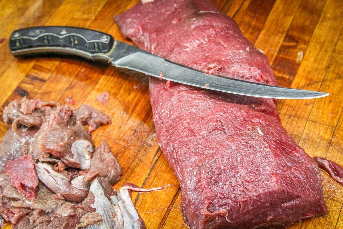 Trim away the freezer-burned portion of the meat to make it usable.