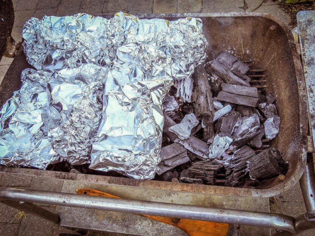 Nestle the packets into the coal bed of a campfire or charcoal grill.