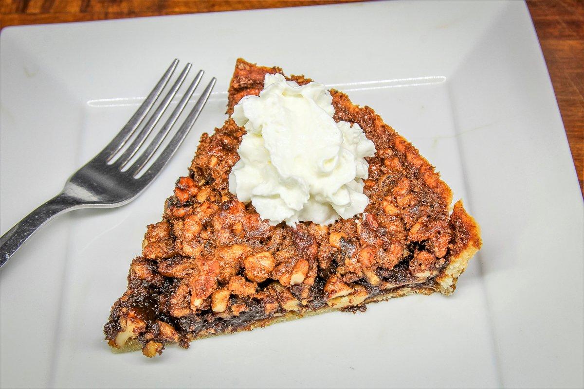 Top the tart with whipped cream before serving.