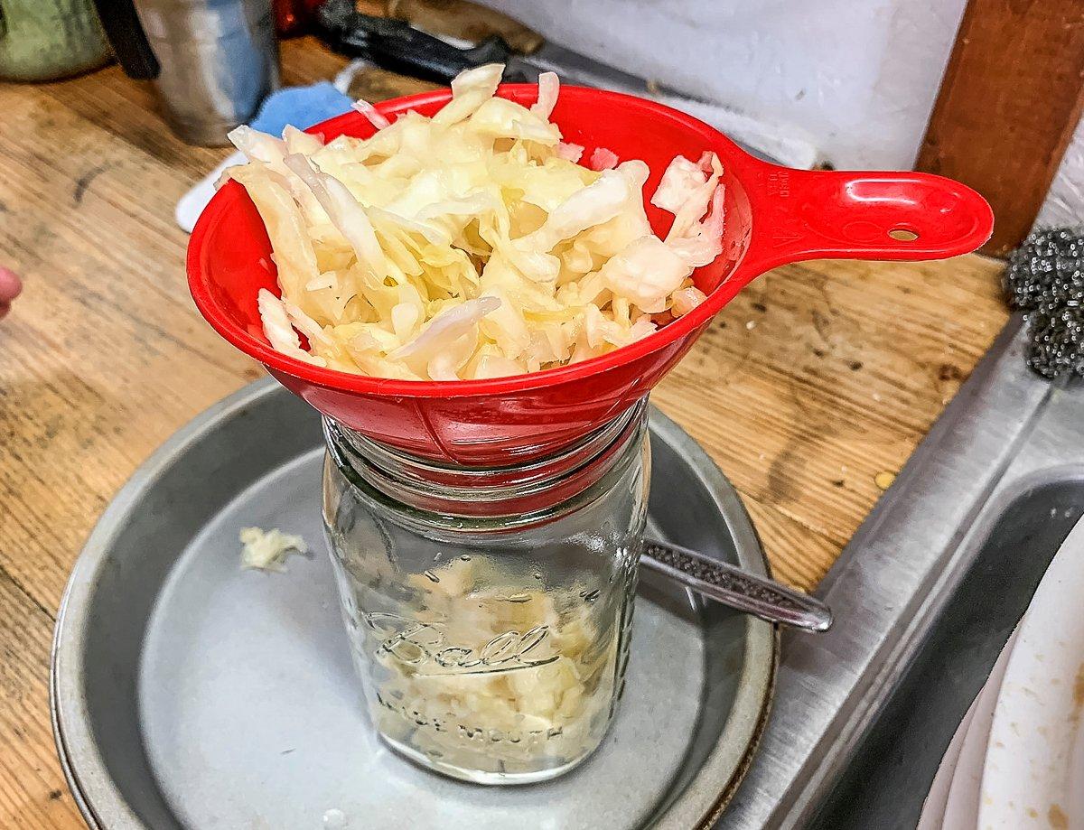 Tightly pack the finished kraut into cleaned quart jars.