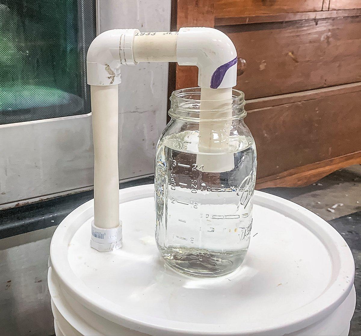 Use PVC pipe and a jar of salted distilled water to allow the gas to escape from the fermentation process and prevent harmful bacteria from entering the bucket.
