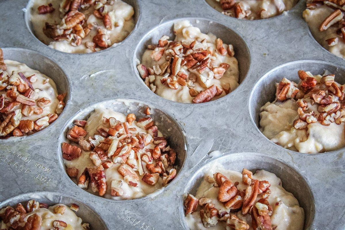 Spoon the batter into a greased muffin tin, then top with remaining pecans.