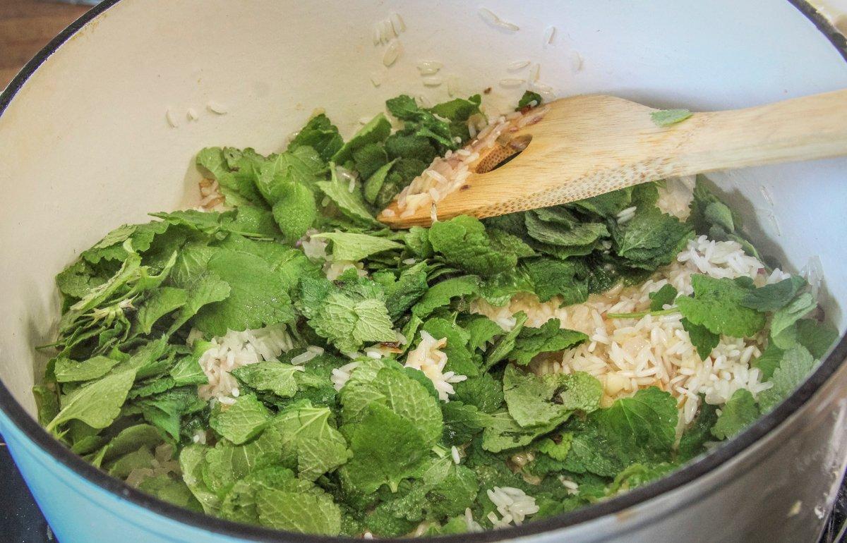Add the cleaned leaves to the uncooked rice before adding the stock.