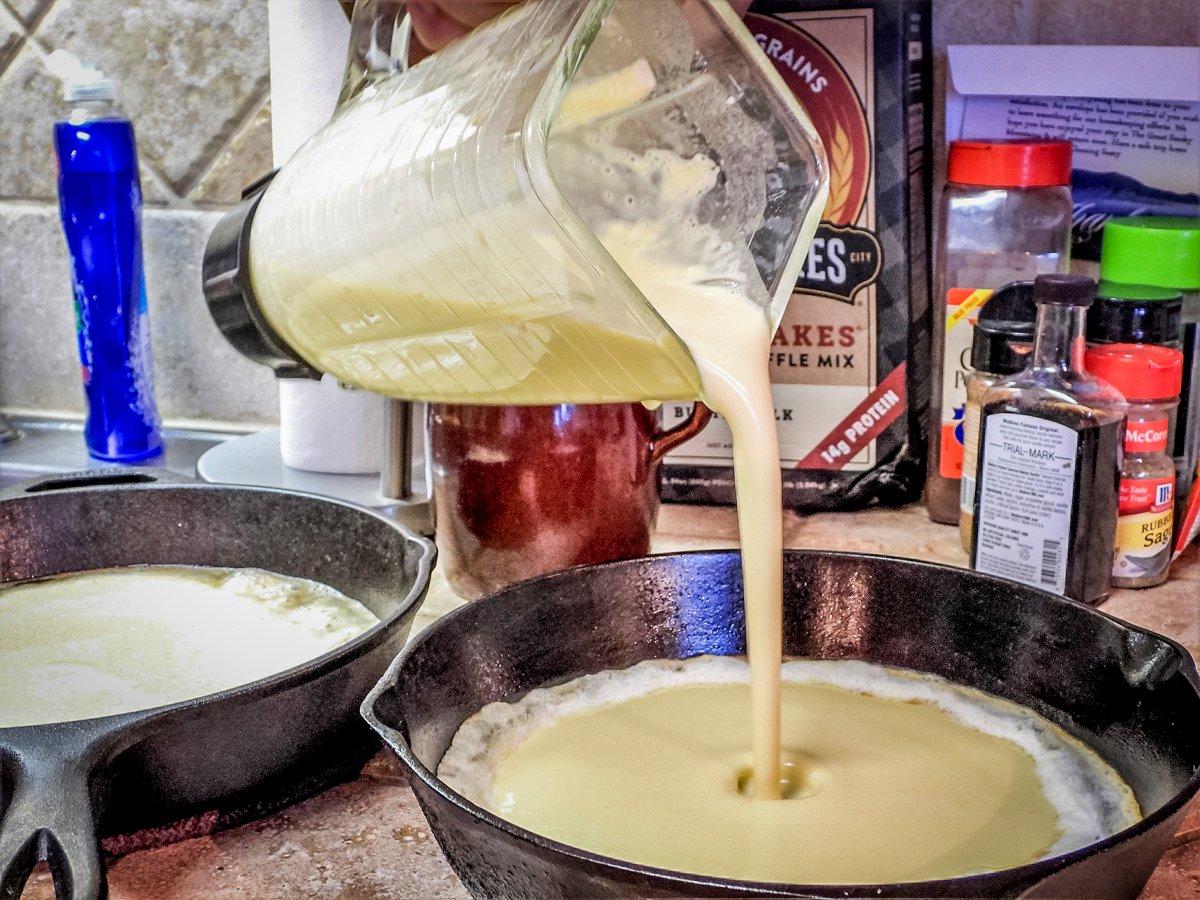 Pour the batter into the hot, buttered skillet.