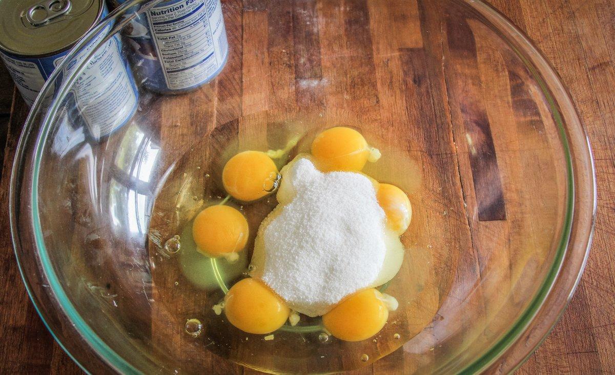 Start by mixing sugar into eggs.