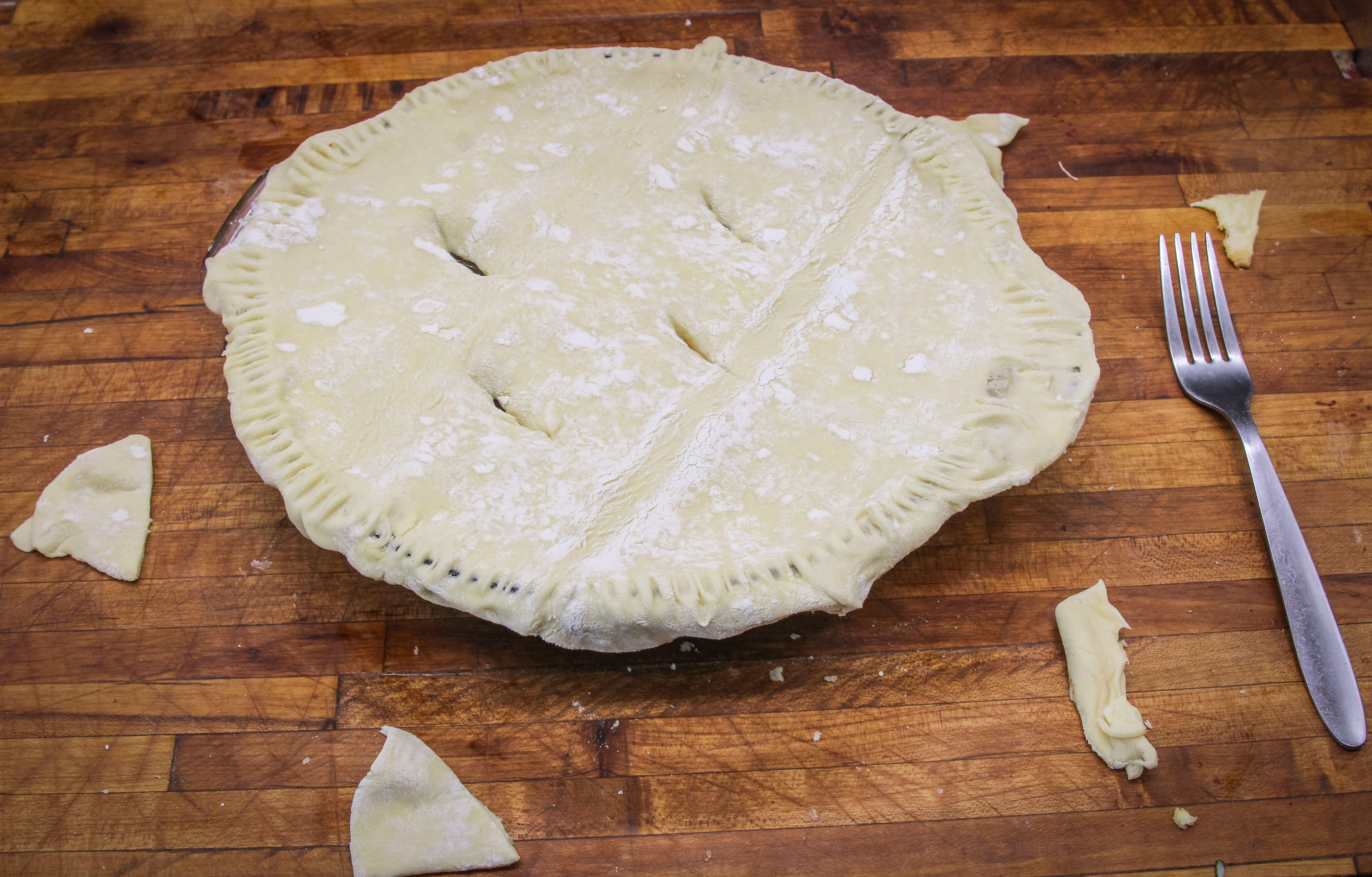 Top the pie with another sheet of puff pastry then crimp the edges with a fork.