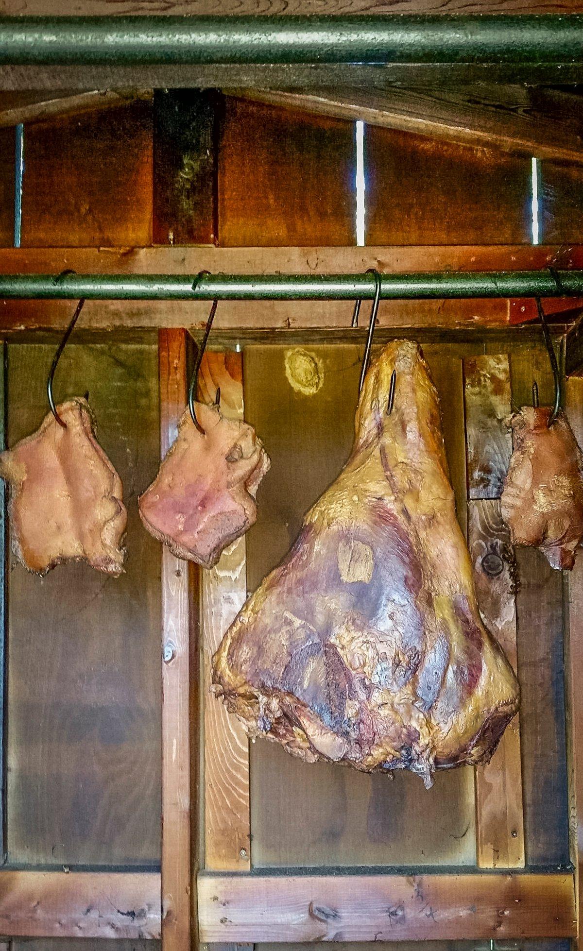We cure our hams in a traditional salt box, then hang in the smokehouse for cold smoking before drying.