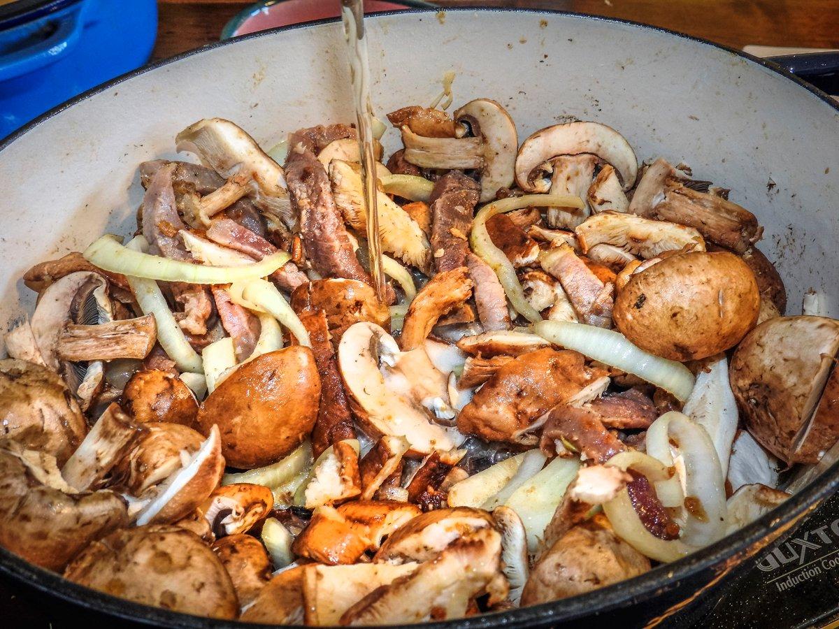 Pour the beer back into the pot before returning the rabbit to braise.