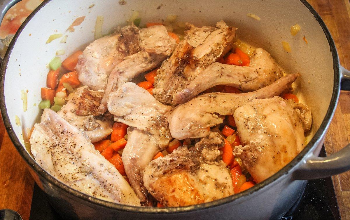 Brown then simmer the vegetables and rabbit before picking the meat from the bone.