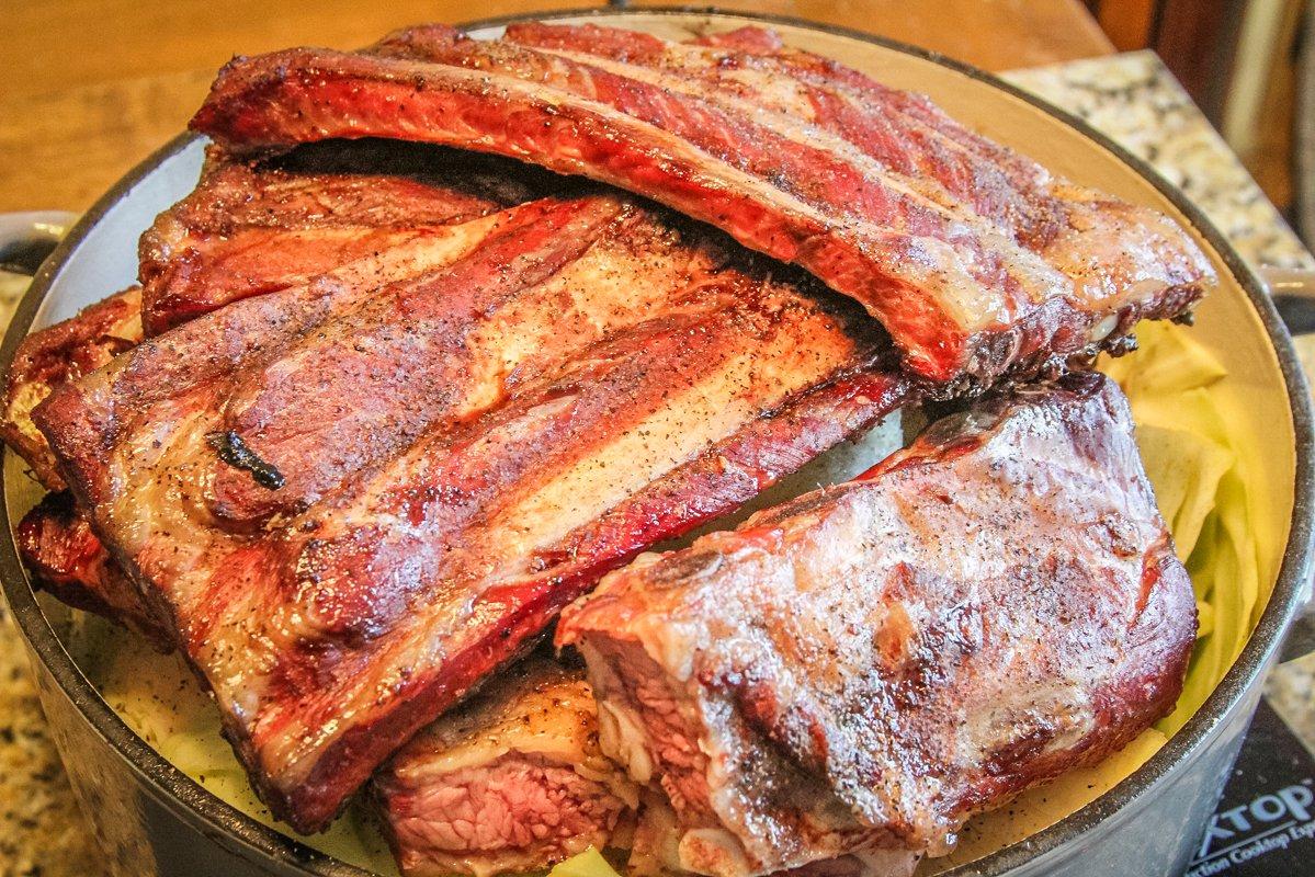 Top the cabbage with the grilled ribs before placing pot in oven.