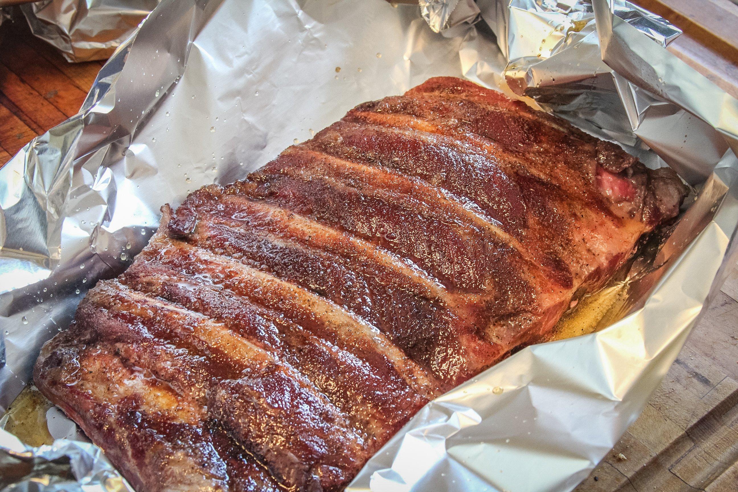 Drizzle the ribs with the glaze, then wrap tightly in foil and continue cooking.