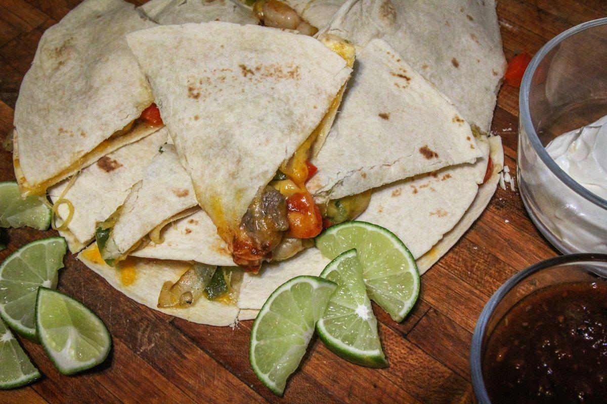 Top the quesadillas with a second tortilla, bake, then cut into wedges for serving.
