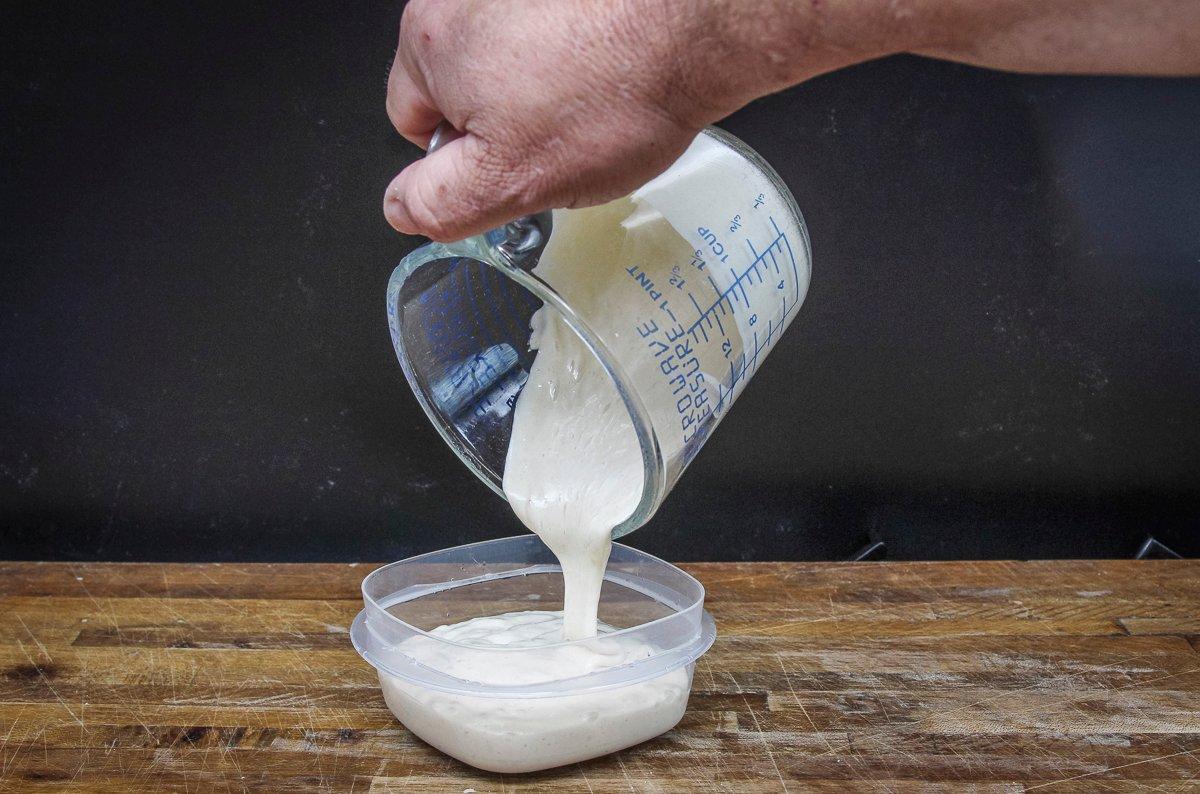 Pour your starter into plastic containers with a tight-fitting lid to store in the freezer.