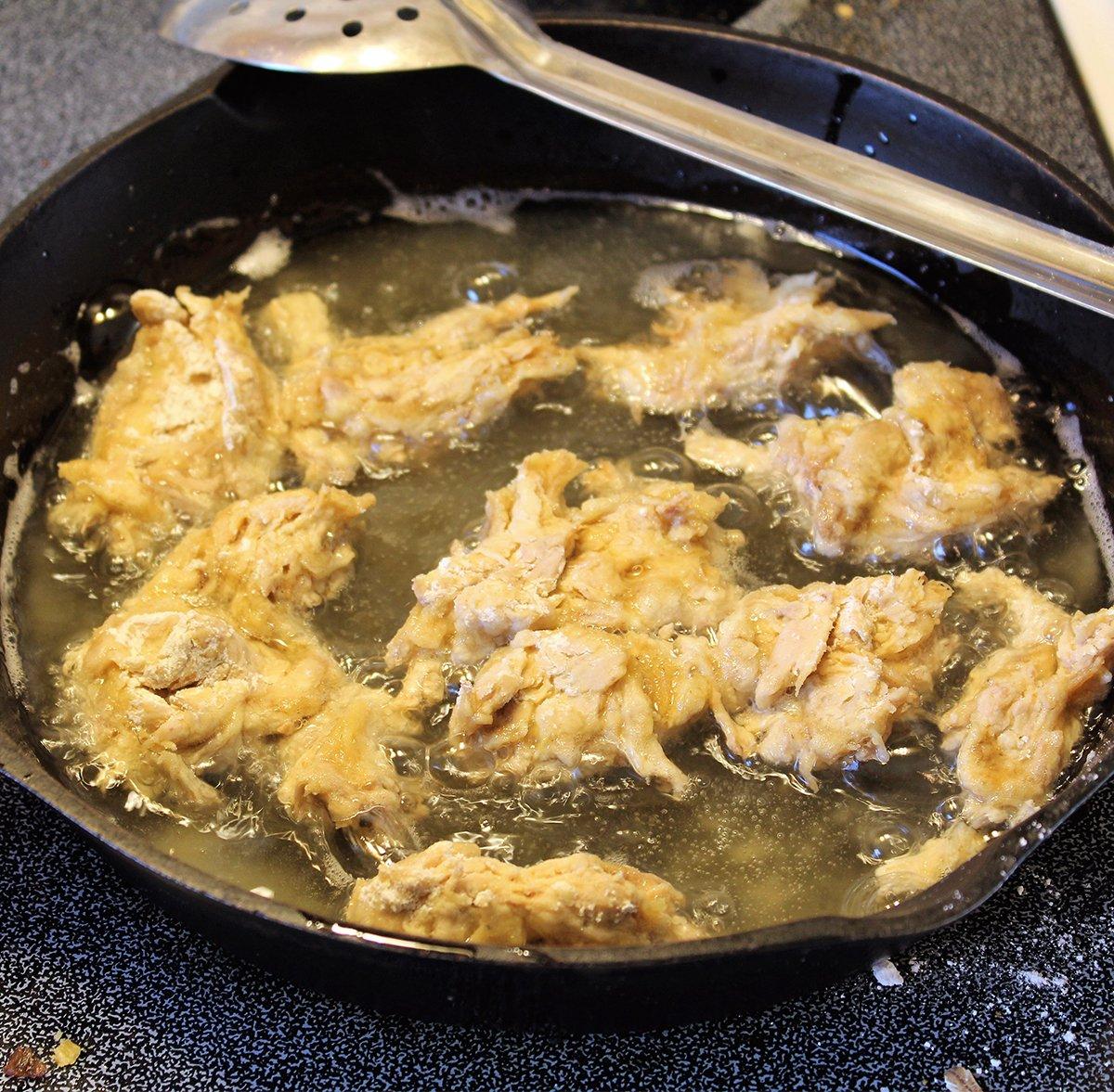 After coating the squirrel meat in beaten egg and seasoned flour, fry it to a crispy golden brown.