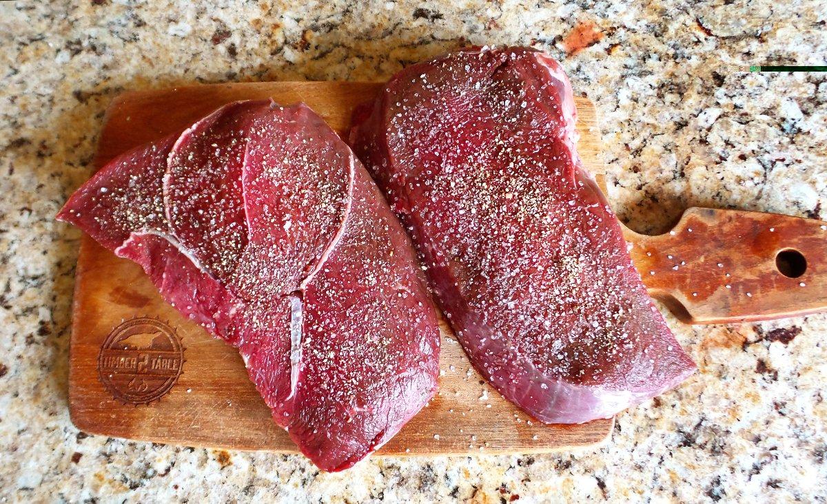 A simple sprinkle of salt and pepper is all the seasoning the elk steaks need.