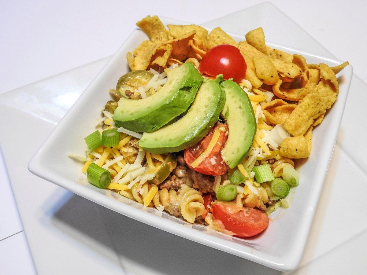 Top the salad with diced green onions, a sliced avocado, and some corn chips for a little crunch.