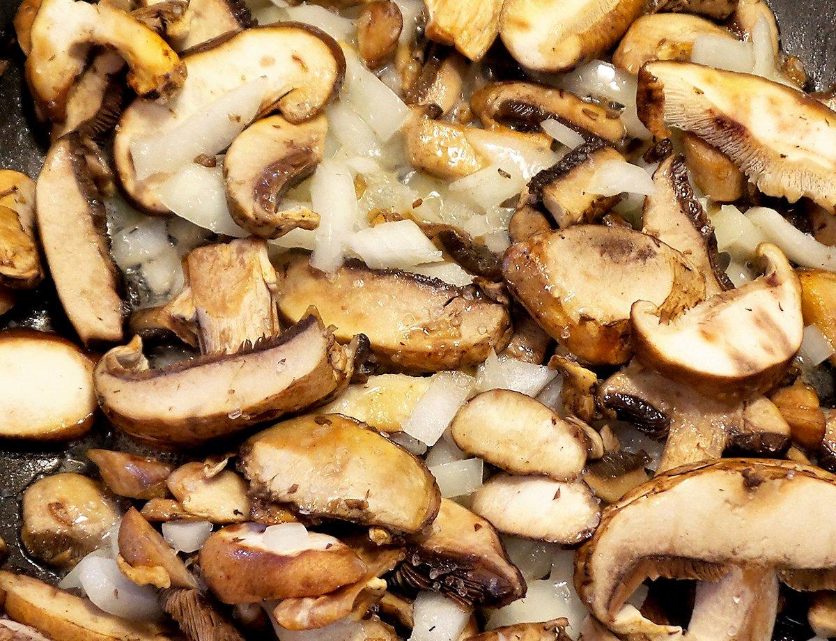 Saute the onions and mushrooms in butter before adding them to the scrambled eggs.