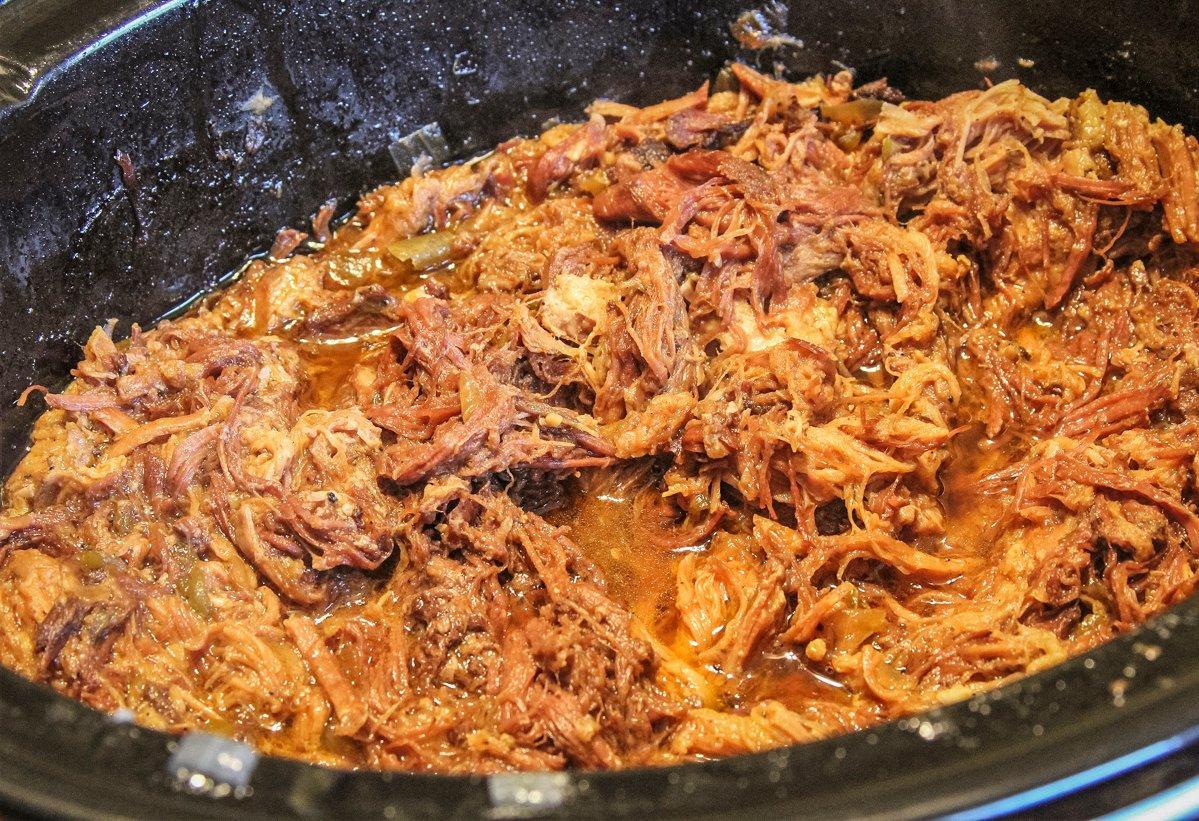 Cook the meat along with the onions, garlic and green chile peppers until the roasts break down and shred.