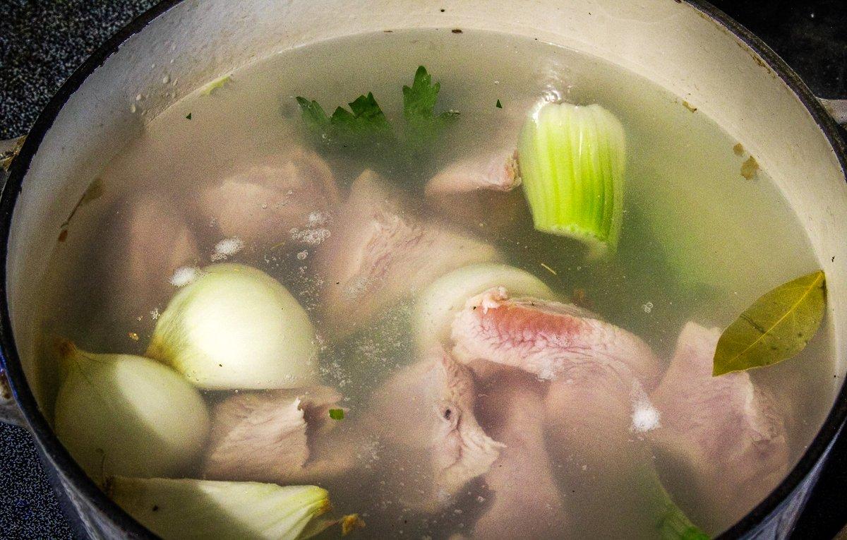 Simmer the turkey with aromatic vegetables until it shreds easily.