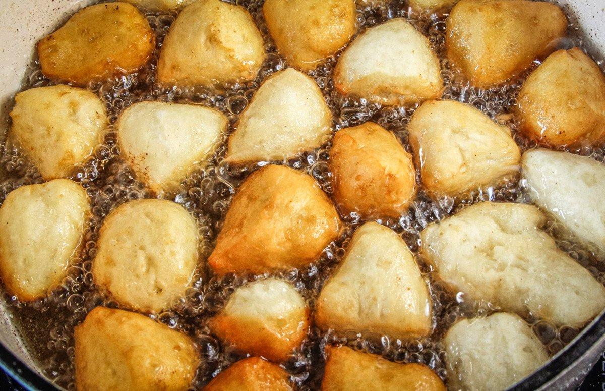 Fry the biscuit dough until it is crispy golden on the surface and just cooked through.