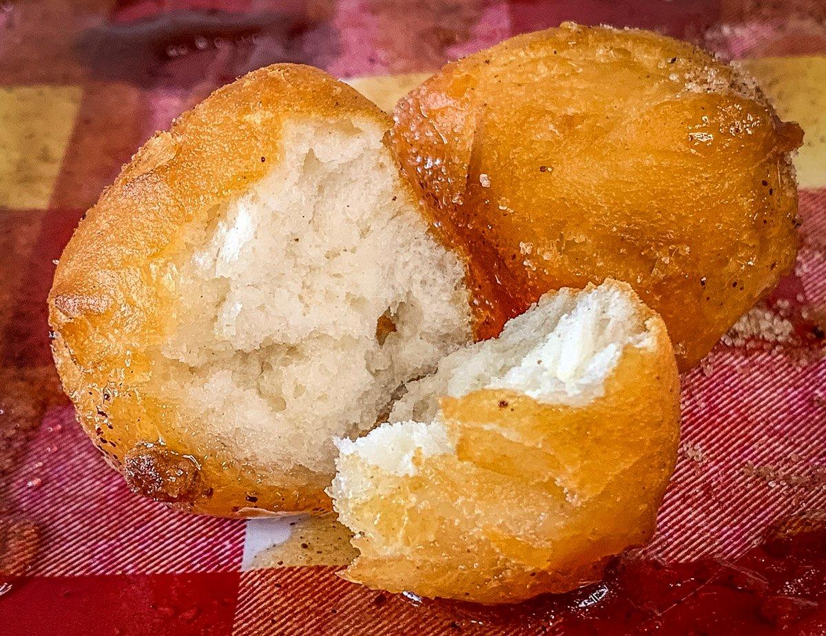 The fried biscuit dough is crispy on the surface and tender in the center.