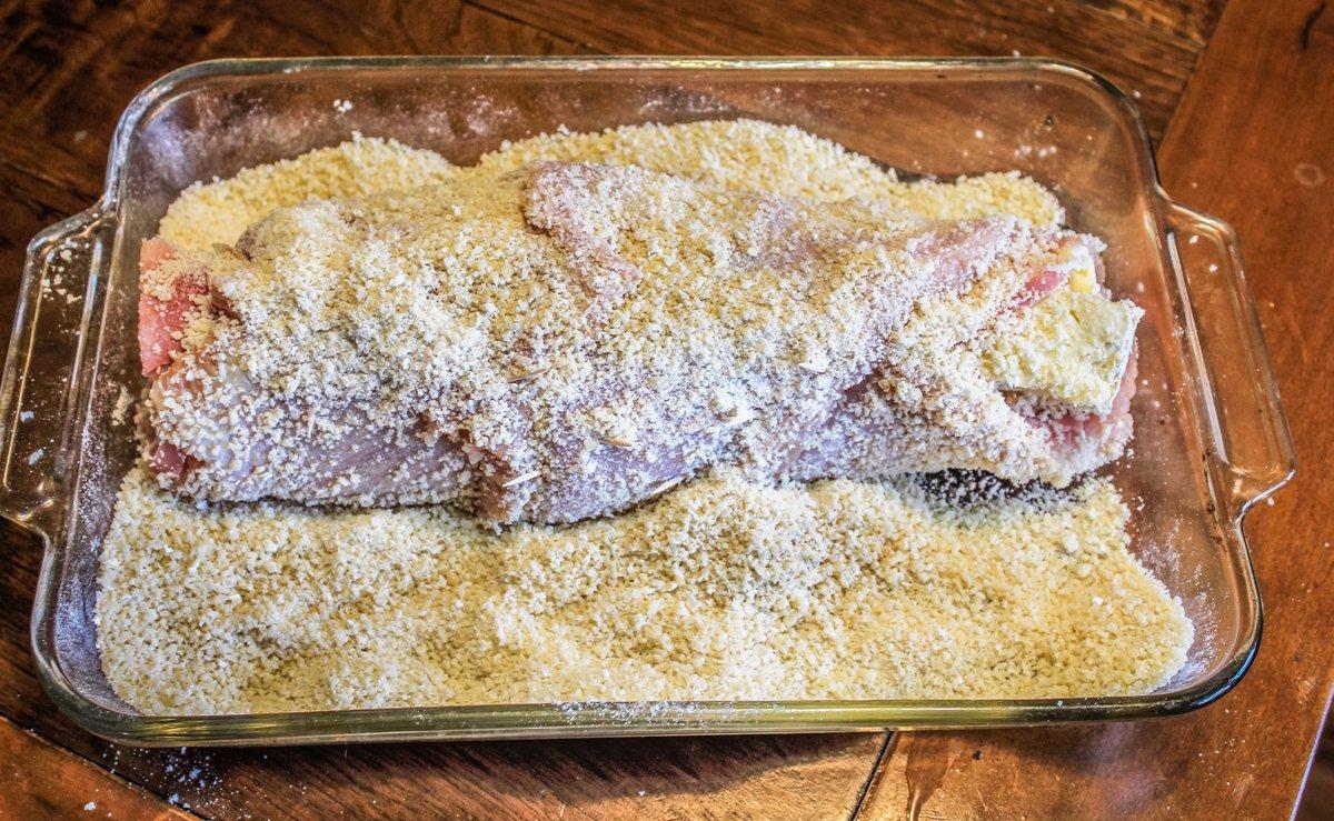 Dredge the roll in the bread crumb, flour, Parmesan cheese mixture.