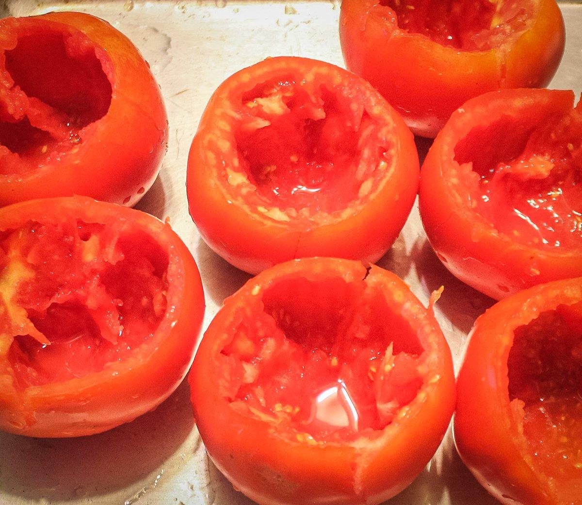 Use a spoon to hollow out the tomatoes into bowls.
