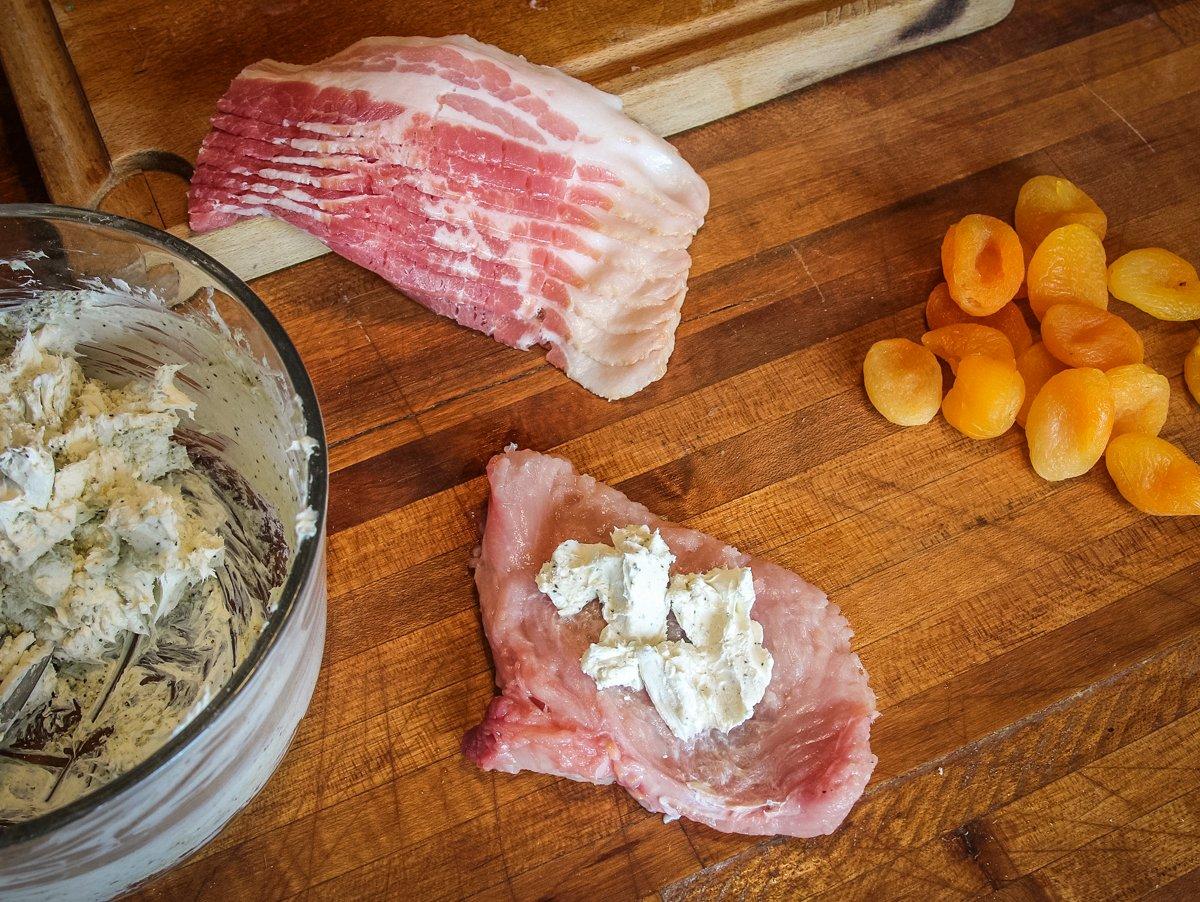 Smear some of the seasoned cream cheese into the center of the turkey then add an apricot.