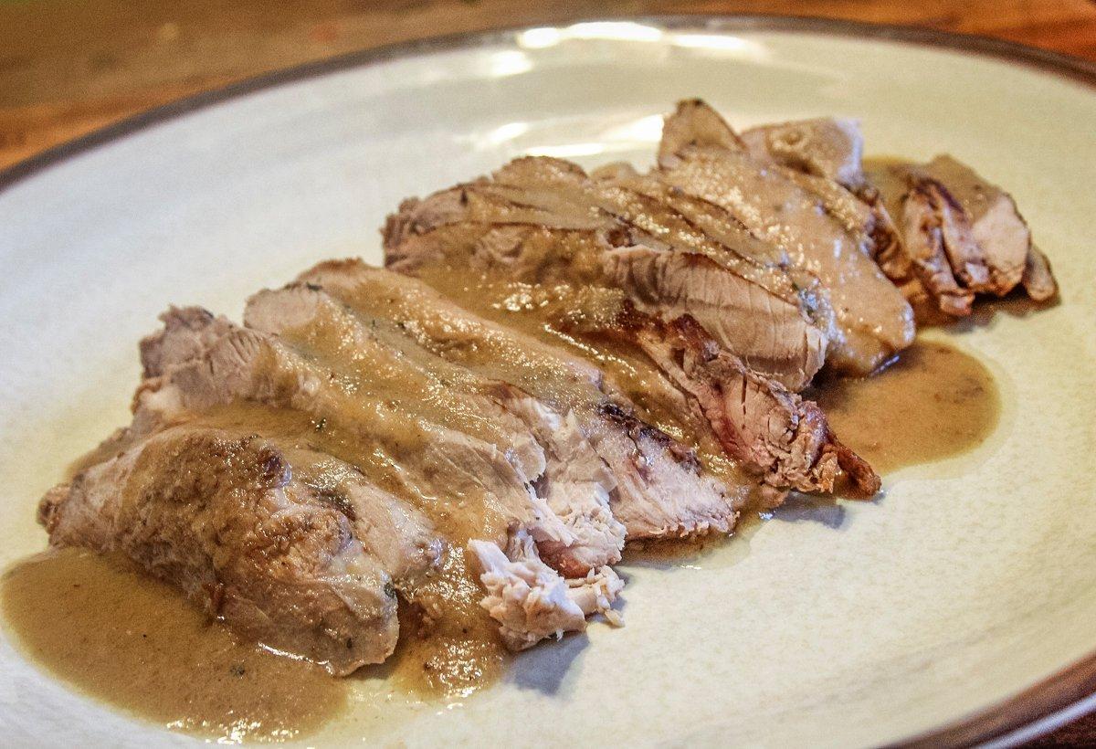 Serve the sliced turkey breast topped with gravy.