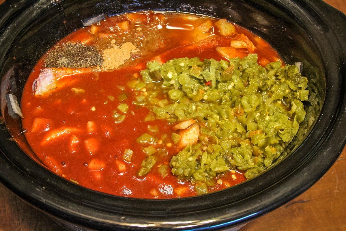 Add the enchilada sauce, peppers, onions, spices and seasonings to the slow cooker.