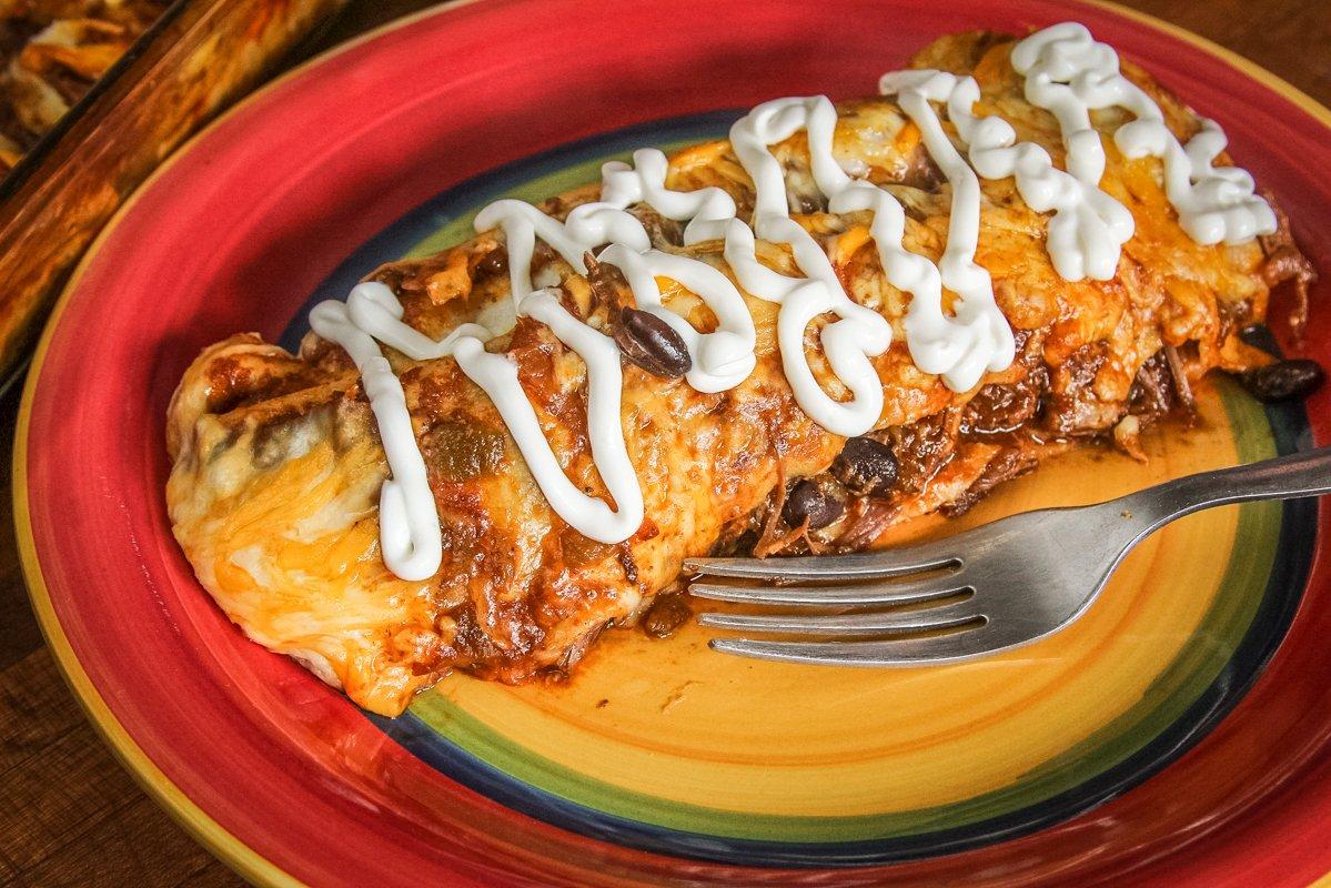 Top the enchiladas with sour cream before serving, if desired.
