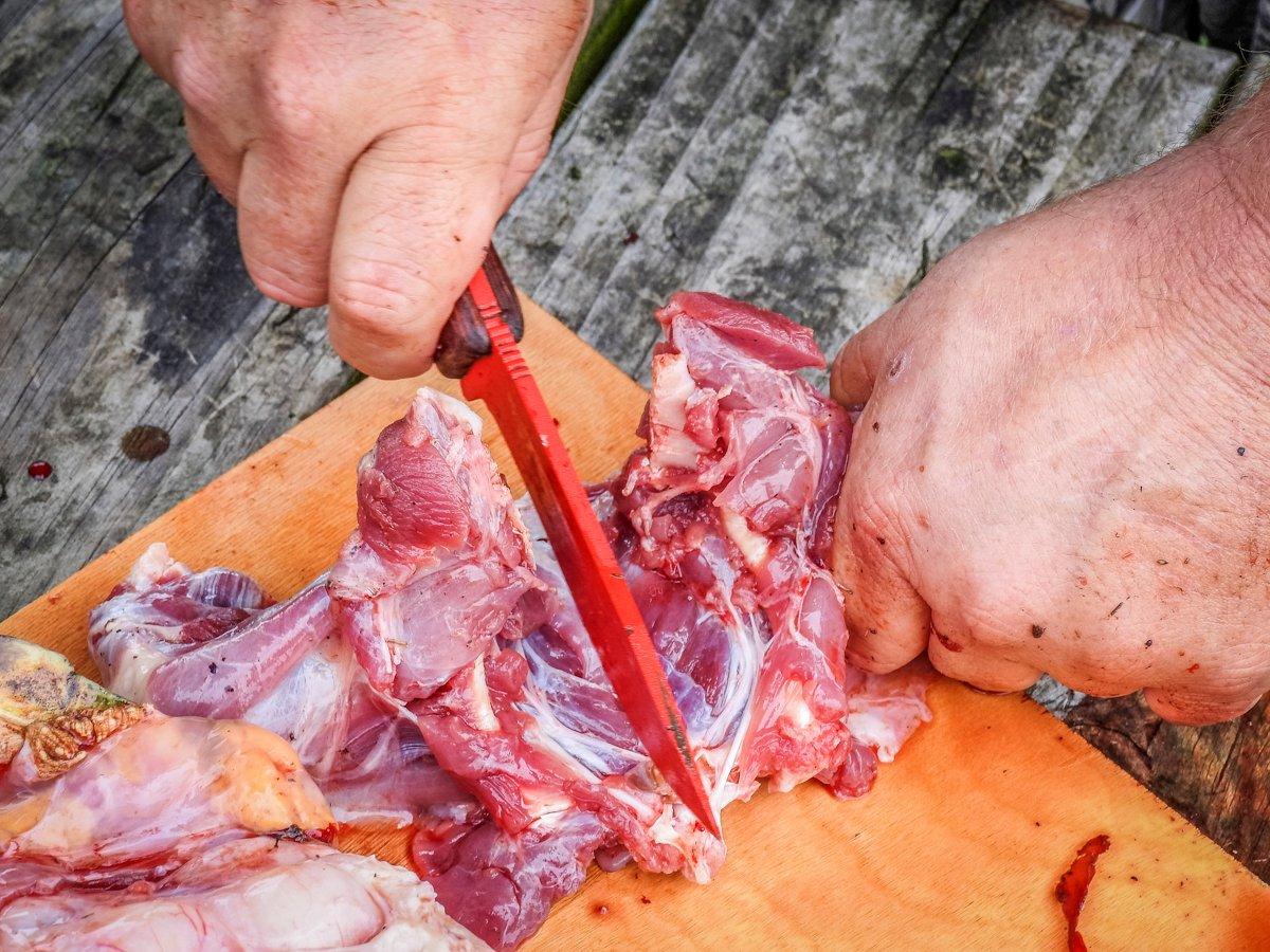 Use a heavy knife to separate the hind legs