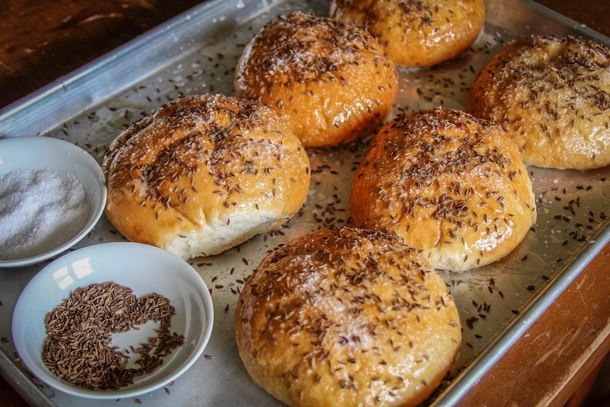 Brush fresh Kaiser rolls with butter, then sprinkle heavily with kosher salt and caraway seeds before baking.