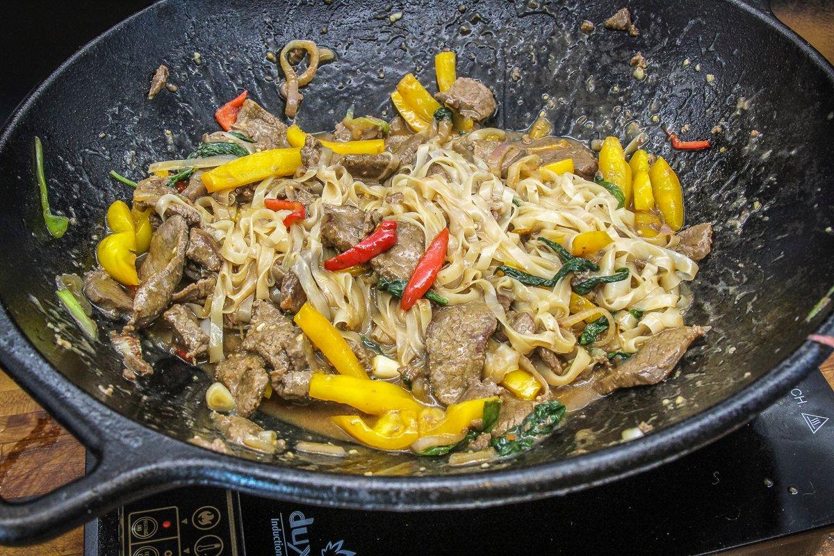 Drain the noodles then add them to the wok before adding the sauce.