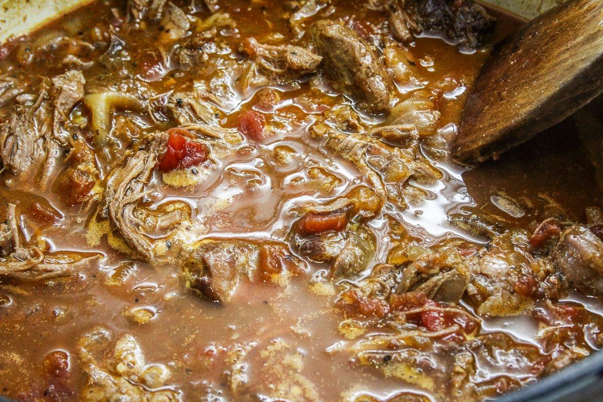 Return the shredded meat to the thickened gravy to heat through.