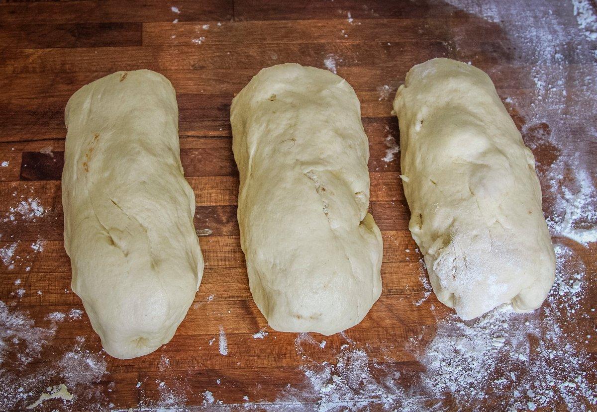 After the first rise, punch down and knead the dough again, then cut into 3 small loaves before rising a second time.