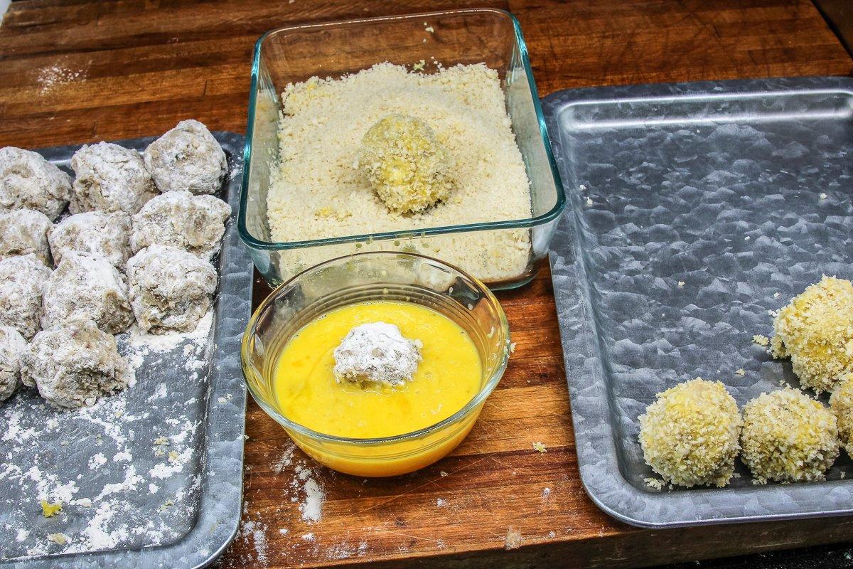 Dust the bitterballen with flour, dip in egg wash, then roll in panko breadcrumbs.