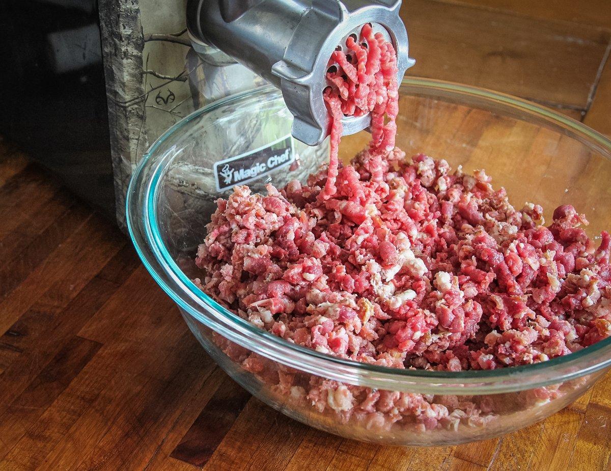 Alternate the bacon and the venison evenly as you grind.