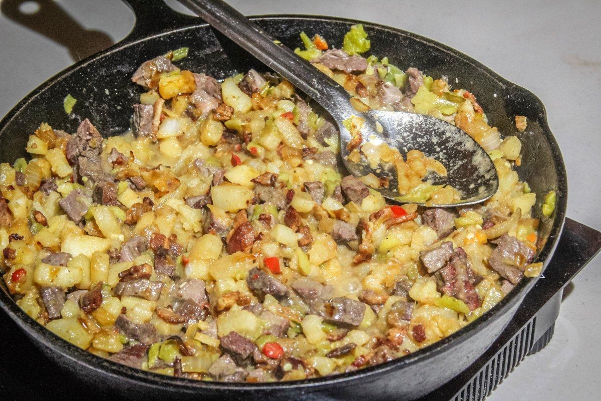 Add the cooked potatoes and beaten eggs to the venison pan and stir to blend.