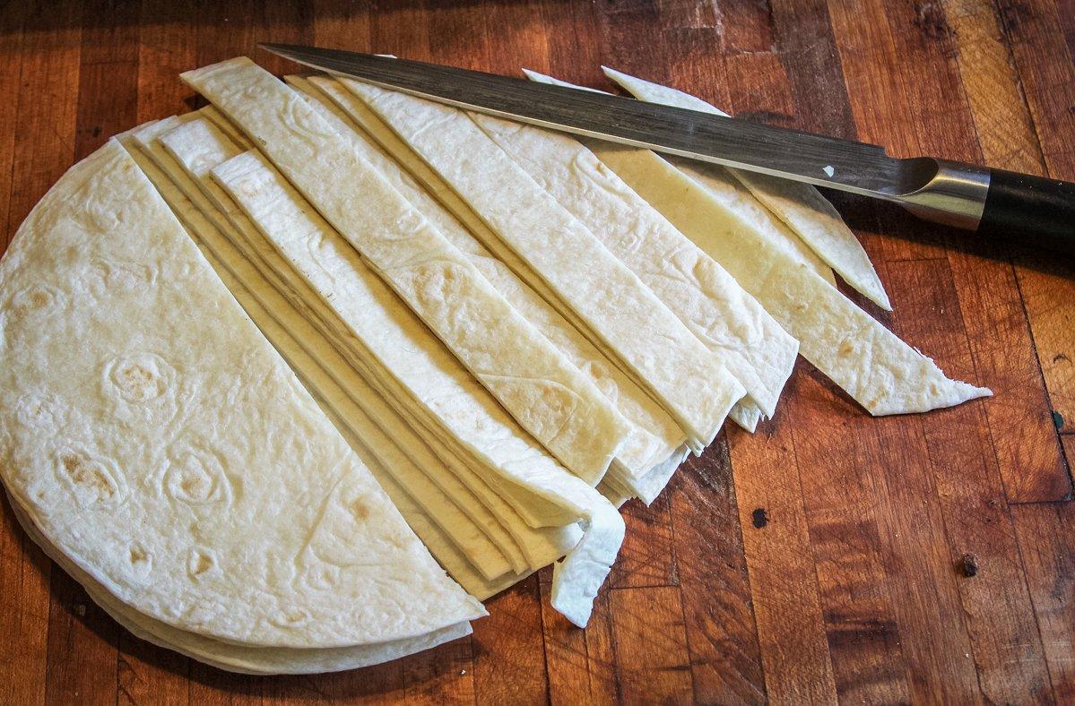 Cut flour tortillas into strips.