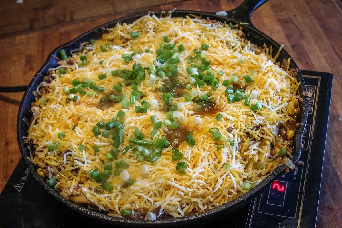 Add the cheese and green onions to the top of the skillet and let the cheese melt.