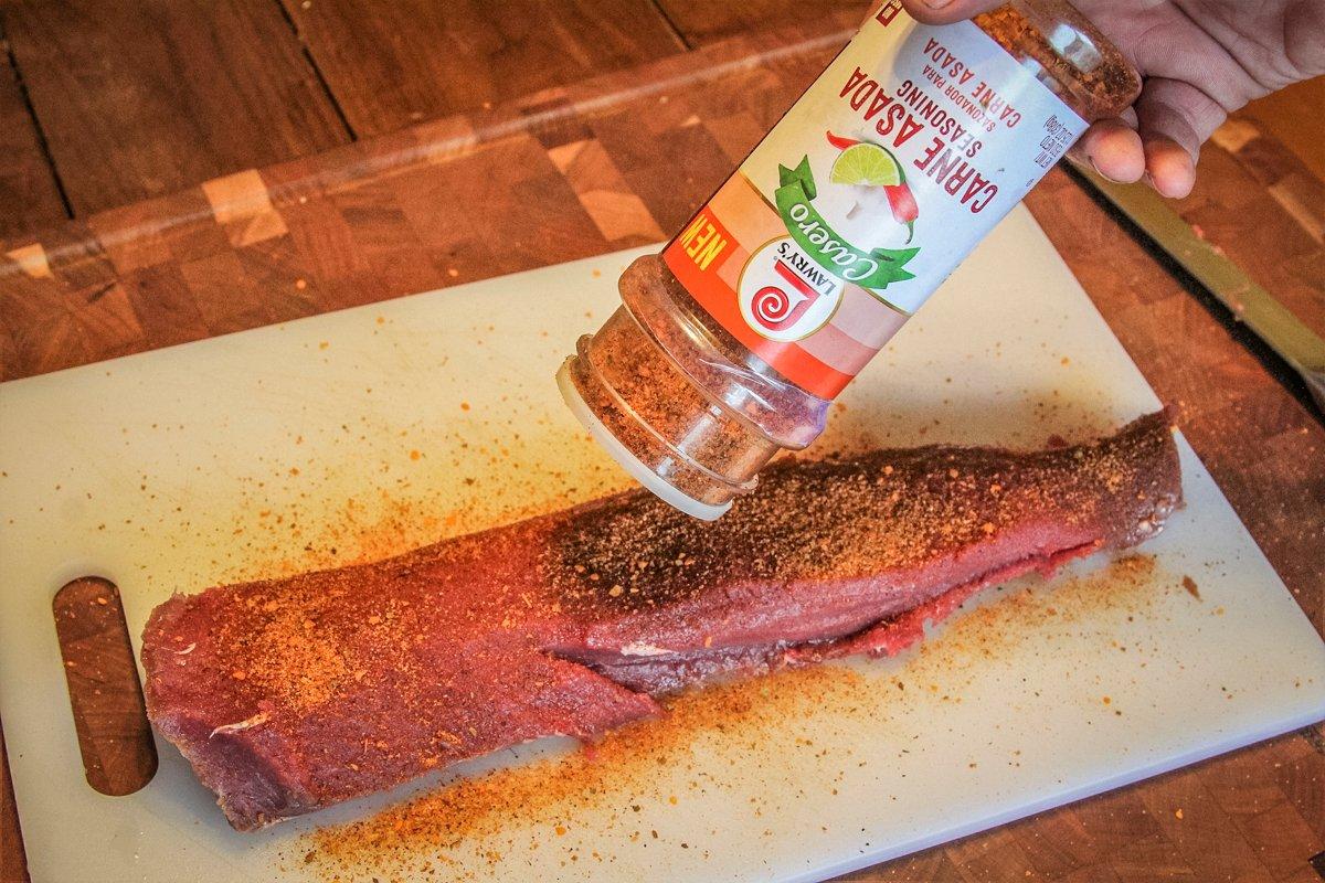 Season the backstrap with your favorite carne asada seasoning blend.