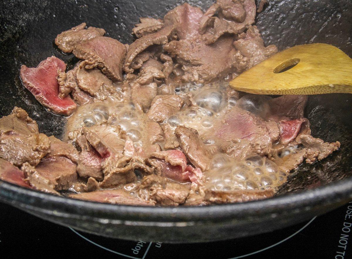 Stir fry the meat over high heat for a minute or two to brown.
