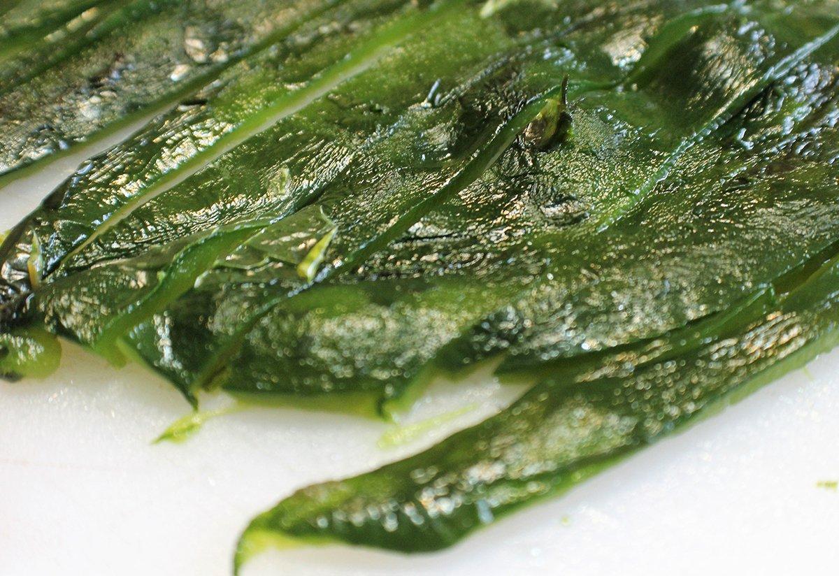 Roast the poblano peppers, then skin and seed them before cutting them up for the sauce.