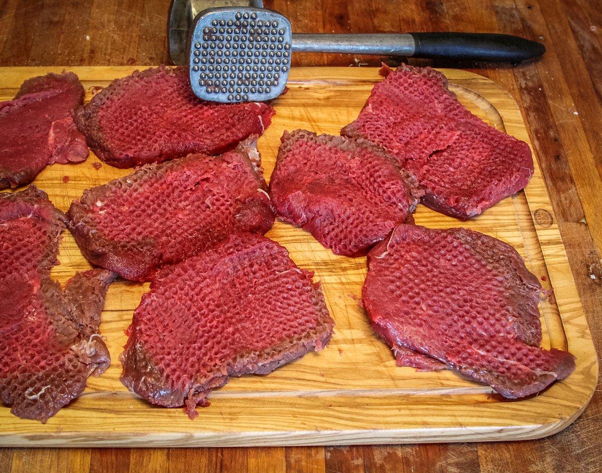 Pound the backstrap medallions with a meat mallet to flatten and tenderize.